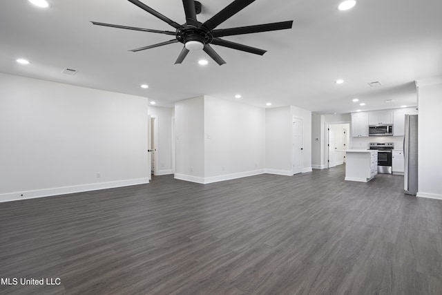 unfurnished living room featuring recessed lighting, a ceiling fan, dark wood-type flooring, and baseboards