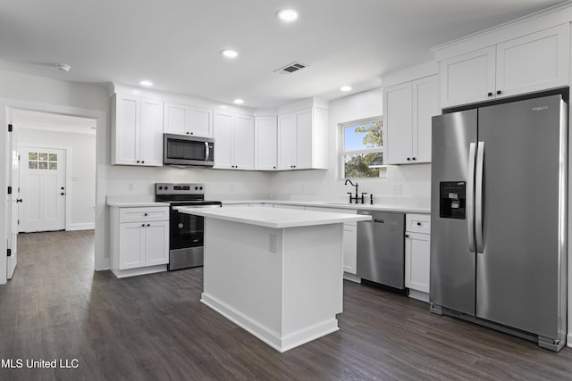 kitchen featuring visible vents, a sink, appliances with stainless steel finishes, white cabinets, and light countertops