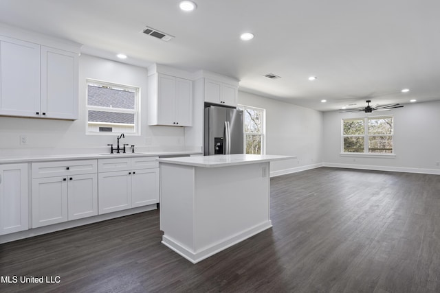 kitchen with a sink, visible vents, recessed lighting, and stainless steel refrigerator with ice dispenser