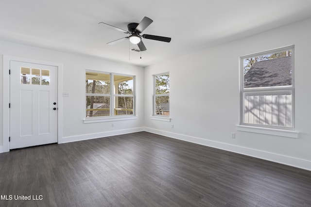 foyer entrance with dark wood finished floors, a ceiling fan, and baseboards