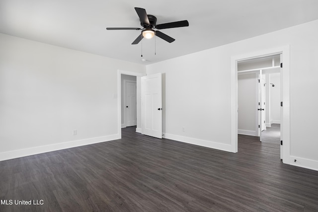 unfurnished bedroom featuring dark wood-style floors, a ceiling fan, and baseboards