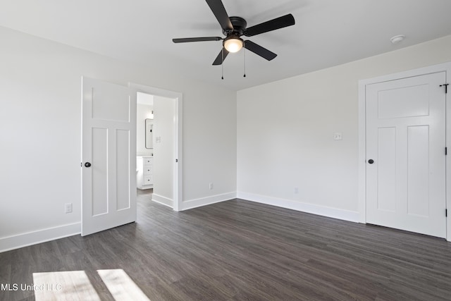 unfurnished room with dark wood-type flooring, baseboards, and ceiling fan