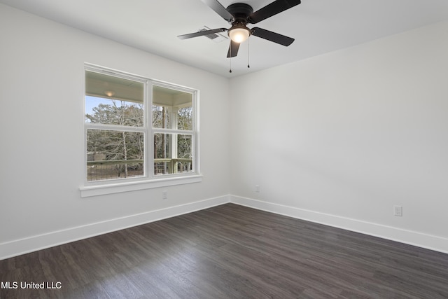 empty room featuring dark wood finished floors, ceiling fan, and baseboards