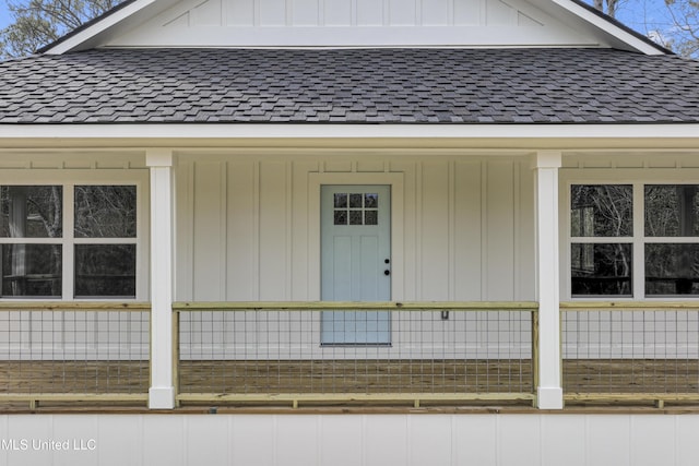 doorway to property featuring roof with shingles