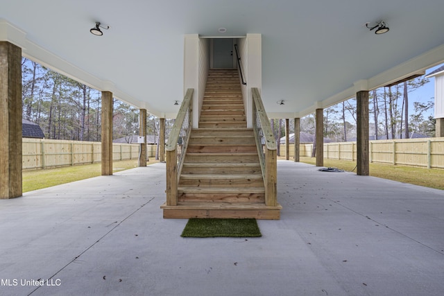 view of patio featuring stairs and a fenced backyard