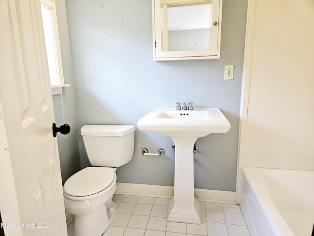 bathroom with toilet, tile patterned flooring, and a bathtub