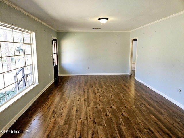 spare room featuring crown molding and dark wood-type flooring