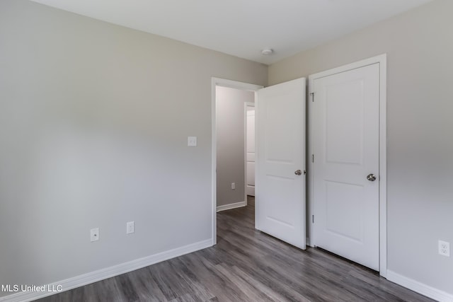13262 Turtle Creek Pkwy, Gulfport, MS 39503 - unfurnished bedroom featuring wood finished floors and baseboards