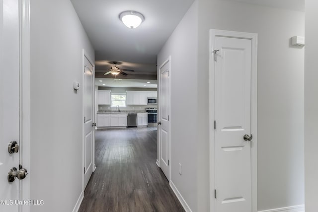 13262 Turtle Creek Pkwy, Gulfport, MS 39503 - hallway with dark wood finished floors, a sink, and baseboards