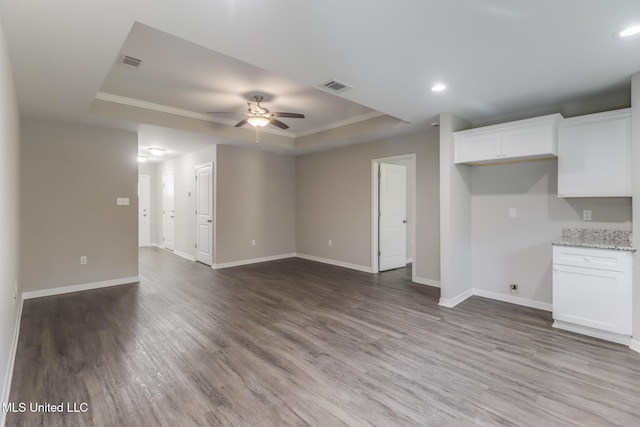 13262 Turtle Creek Pkwy, Gulfport, MS 39503 - unfurnished living room with a tray ceiling, a ceiling fan, dark wood finished floors, baseboards, and recessed lighting