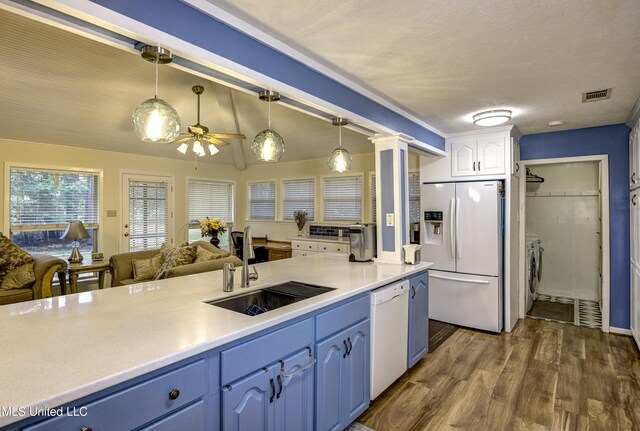 911 Newitt Vick Dr, Vicksburg, MS 39183 - kitchen with white appliances, independent washer and dryer, blue cabinetry, and ceiling fan