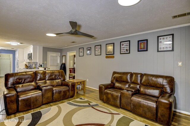 911 Newitt Vick Dr, Vicksburg, MS 39183 - living area featuring wood finished floors, a ceiling fan, baseboards, and a textured ceiling