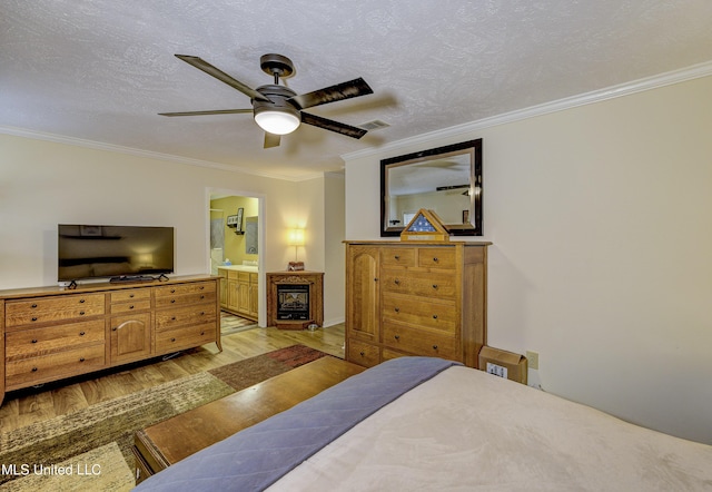 911 Newitt Vick Dr, Vicksburg, MS 39183 - bedroom featuring light wood-type flooring, crown molding, connected bathroom, and a ceiling fan