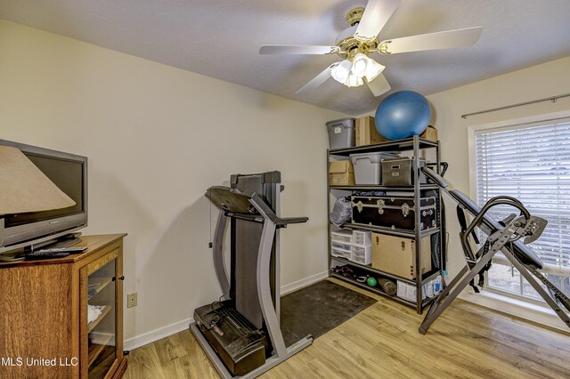 911 Newitt Vick Dr, Vicksburg, MS 39183 - workout area featuring ceiling fan, wood finished floors, and baseboards