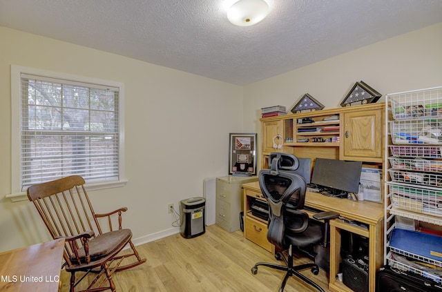 911 Newitt Vick Dr, Vicksburg, MS 39183 - office area featuring light wood-style floors, a textured ceiling, and baseboards