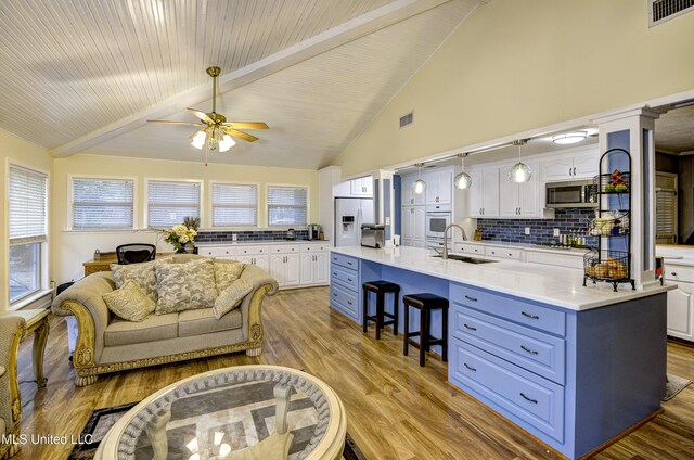 911 Newitt Vick Dr, Vicksburg, MS 39183 - living room with a ceiling fan, light wood finished floors, high vaulted ceiling, and beamed ceiling