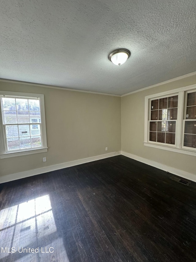 spare room featuring crown molding, dark hardwood / wood-style flooring, and a textured ceiling