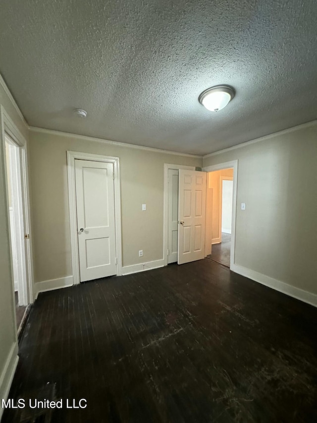 unfurnished room with a textured ceiling and dark wood-type flooring