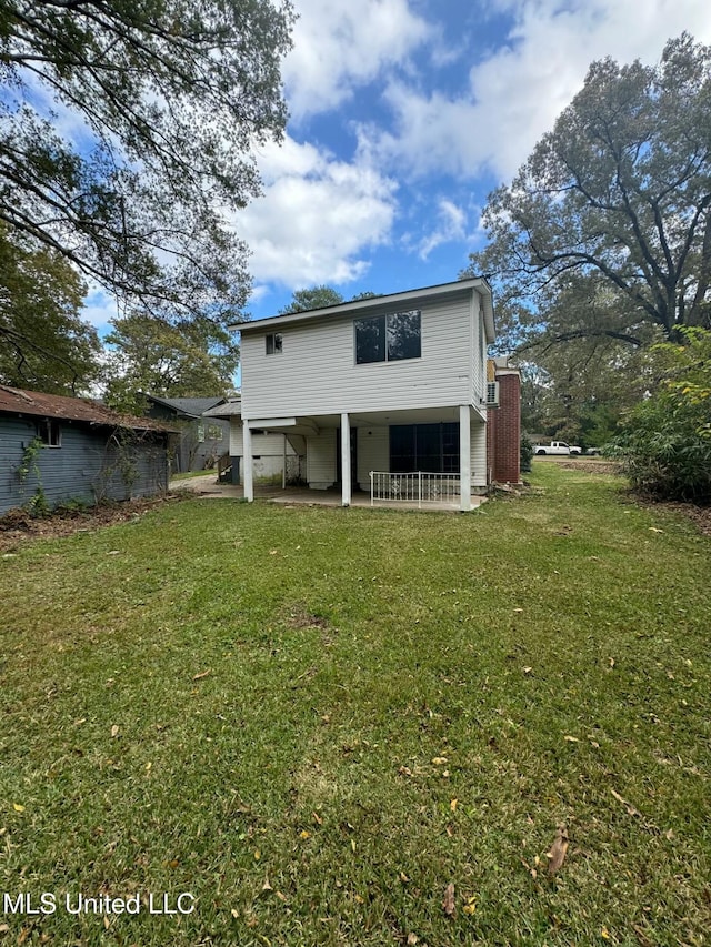 rear view of house with a lawn