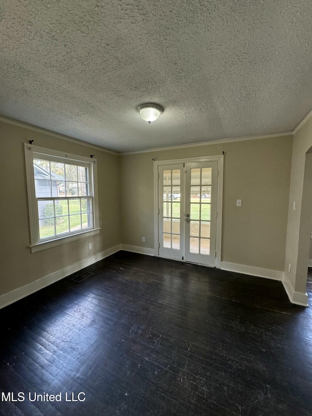 unfurnished room with a textured ceiling, plenty of natural light, french doors, and dark hardwood / wood-style floors