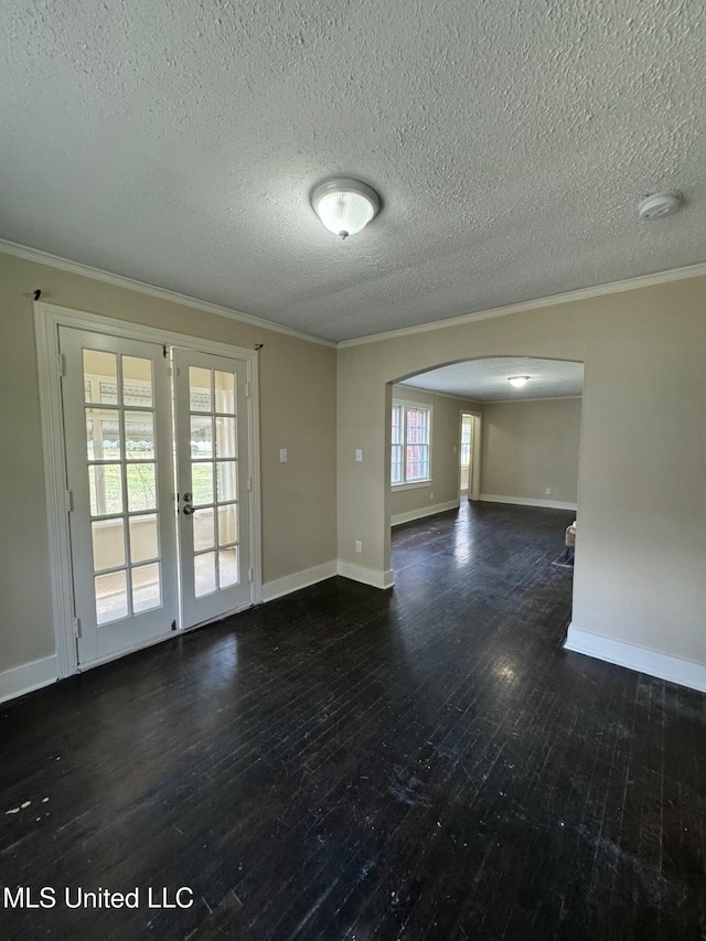 spare room with dark hardwood / wood-style floors, crown molding, and a textured ceiling