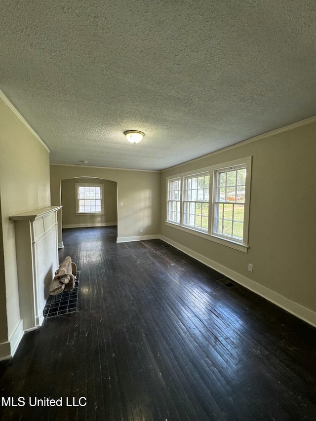 unfurnished living room featuring dark hardwood / wood-style floors, crown molding, and a textured ceiling