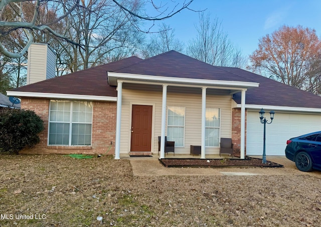 ranch-style home featuring a porch and a garage