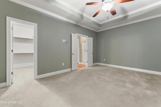 11541 Briarstone Pl, Gulfport, MS 39503 - unfurnished bedroom with a spacious closet, light colored carpet, ornamental molding, a ceiling fan, and a raised ceiling