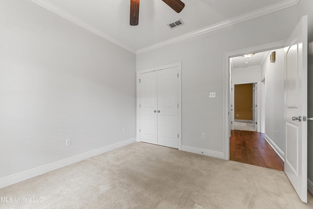 11541 Briarstone Pl, Gulfport, MS 39503 - unfurnished bedroom with ornamental molding, carpet, a closet, and a ceiling fan