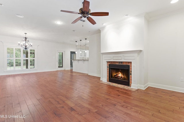 11541 Briarstone Pl, Gulfport, MS 39503 - unfurnished living room with light wood-style floors, a chandelier, a fireplace, crown molding, and ceiling fan