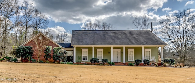 view of front of property with a front yard and covered porch