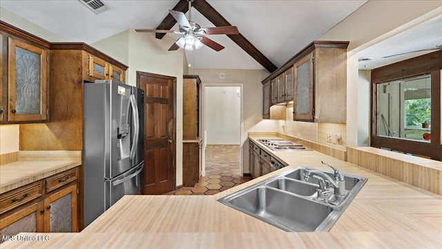 555 Rusk Dr, Brandon, MS 39047 - kitchen with stainless steel appliances, ceiling fan, light countertops, glass insert cabinets, and decorative backsplash