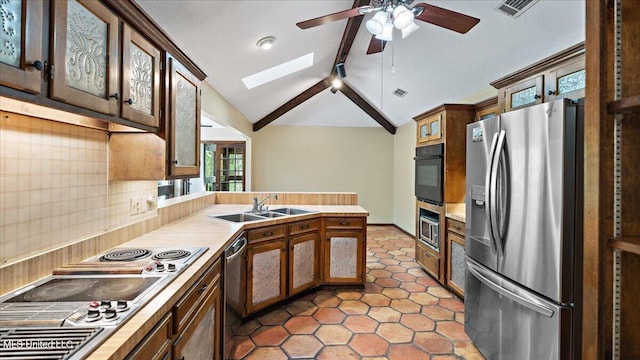 555 Rusk Dr, Brandon, MS 39047 - kitchen with stainless steel appliances, a ceiling fan, a peninsula, a skylight, and light countertops