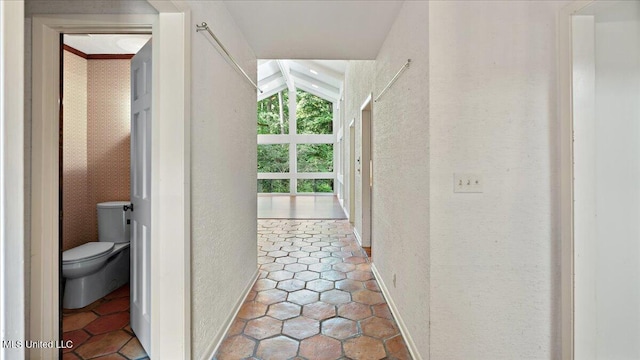 555 Rusk Dr, Brandon, MS 39047 - hallway with a textured wall and vaulted ceiling