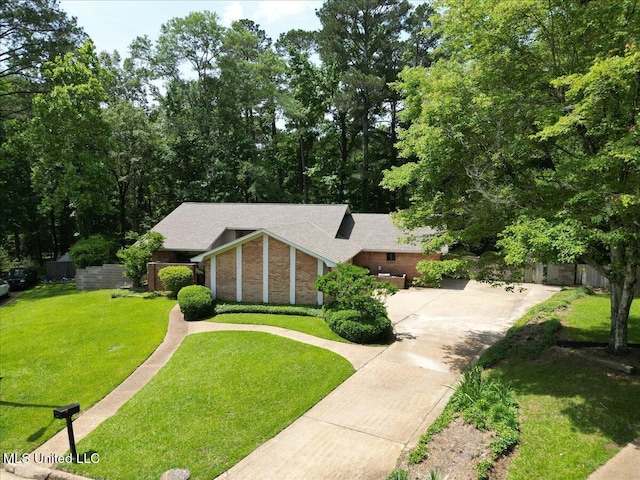 555 Rusk Dr, Brandon, MS 39047 - view of front of house featuring concrete driveway, brick siding, and roof with shingles