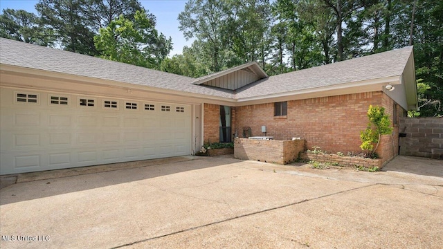 555 Rusk Dr, Brandon, MS 39047 - ranch-style house with brick siding, concrete driveway, a garage, and roof with shingles
