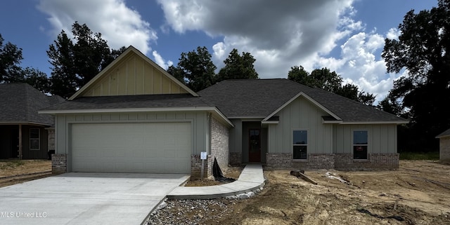 345 Willow Way, Canton, MS 39046 - view of front facade with board and batten siding, a garage, concrete driveway, a shingled roof, and brick siding