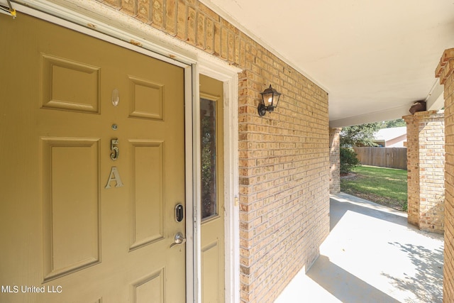 515 Third St Unit 5A, Bay Saint Louis, MS 39520 - doorway to property featuring brick siding and a porch
