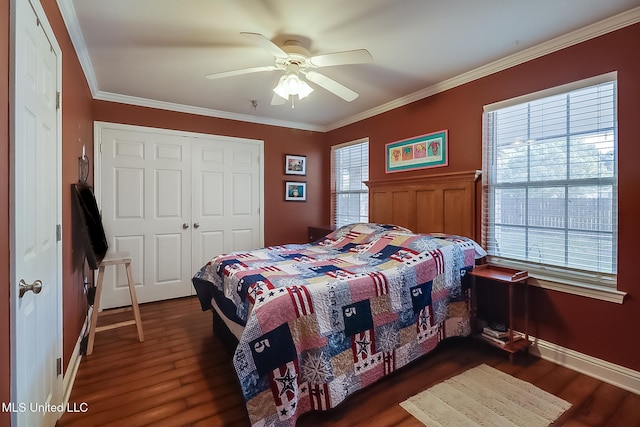 515 Third St Unit 5A, Bay Saint Louis, MS 39520 - bedroom with a ceiling fan, dark wood-style flooring, baseboards, a closet, and ornamental molding