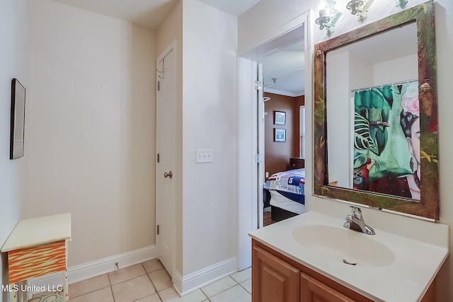 515 Third St Unit 5A, Bay Saint Louis, MS 39520 - ensuite bathroom with vanity, connected bathroom, baseboards, and tile patterned floors