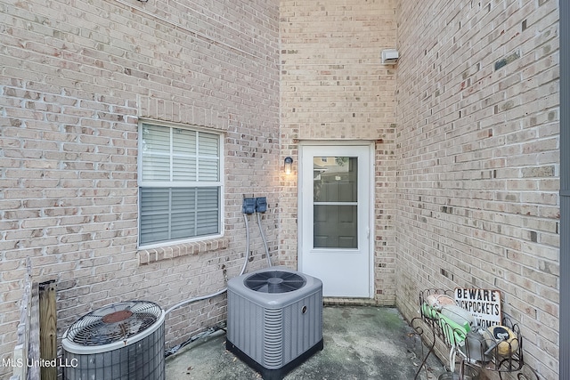 515 Third St Unit 5A, Bay Saint Louis, MS 39520 - doorway to property with cooling unit and brick siding