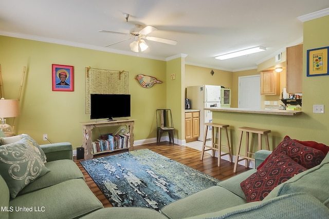 515 Third St Unit 5A, Bay Saint Louis, MS 39520 - living room with crown molding, a ceiling fan, baseboards, wood finished floors, and visible vents
