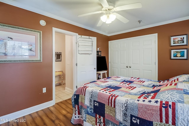 515 Third St Unit 5A, Bay Saint Louis, MS 39520 - bedroom featuring a closet, ornamental molding, wood finished floors, baseboards, and ceiling fan