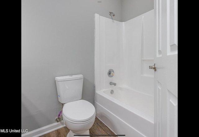 bathroom featuring toilet, shower / bathtub combination, and wood-type flooring