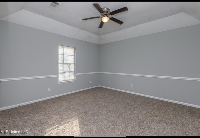 unfurnished room featuring ceiling fan, lofted ceiling, a raised ceiling, and carpet floors