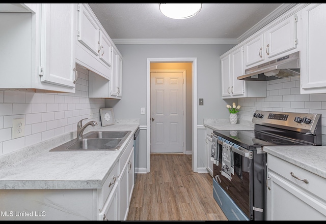 kitchen with white cabinets, stainless steel electric range, ornamental molding, light hardwood / wood-style flooring, and sink