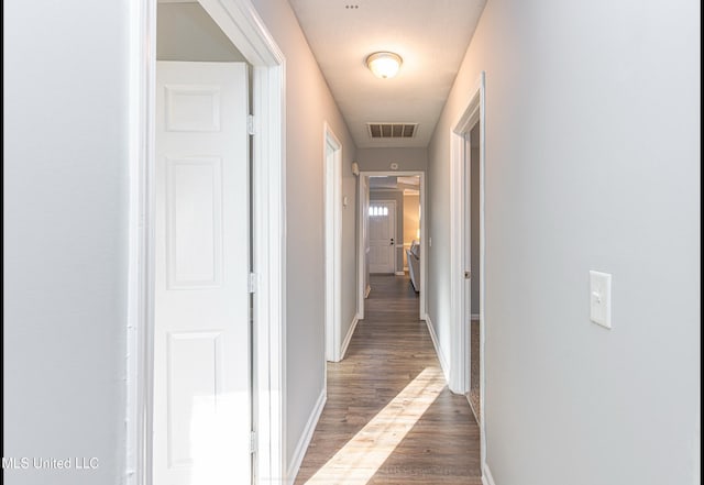 hallway featuring dark wood-type flooring