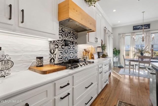 kitchen with tasteful backsplash, dark wood finished floors, custom range hood, ornamental molding, and stainless steel appliances