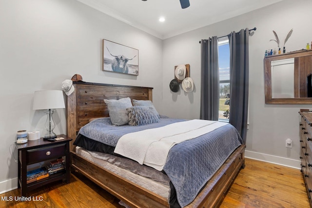 bedroom featuring a ceiling fan, recessed lighting, wood finished floors, and baseboards