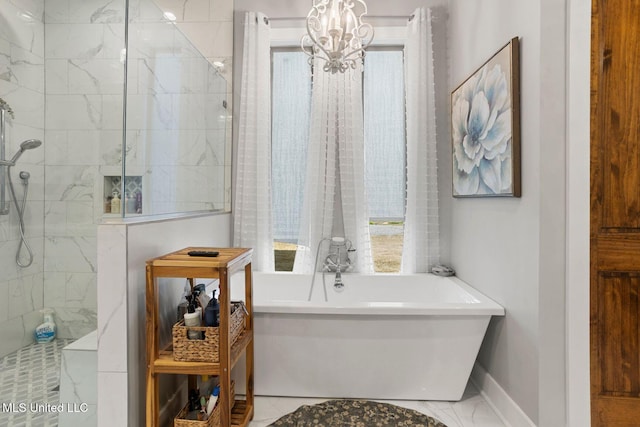 bathroom featuring marble finish floor, baseboards, a freestanding bath, walk in shower, and a chandelier